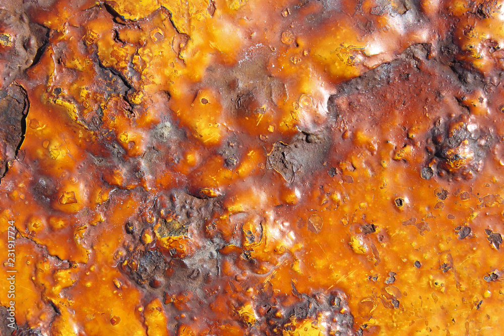 Heavily rusted corroded yellow painted metal cast iron triangular shape surface texture close up detail