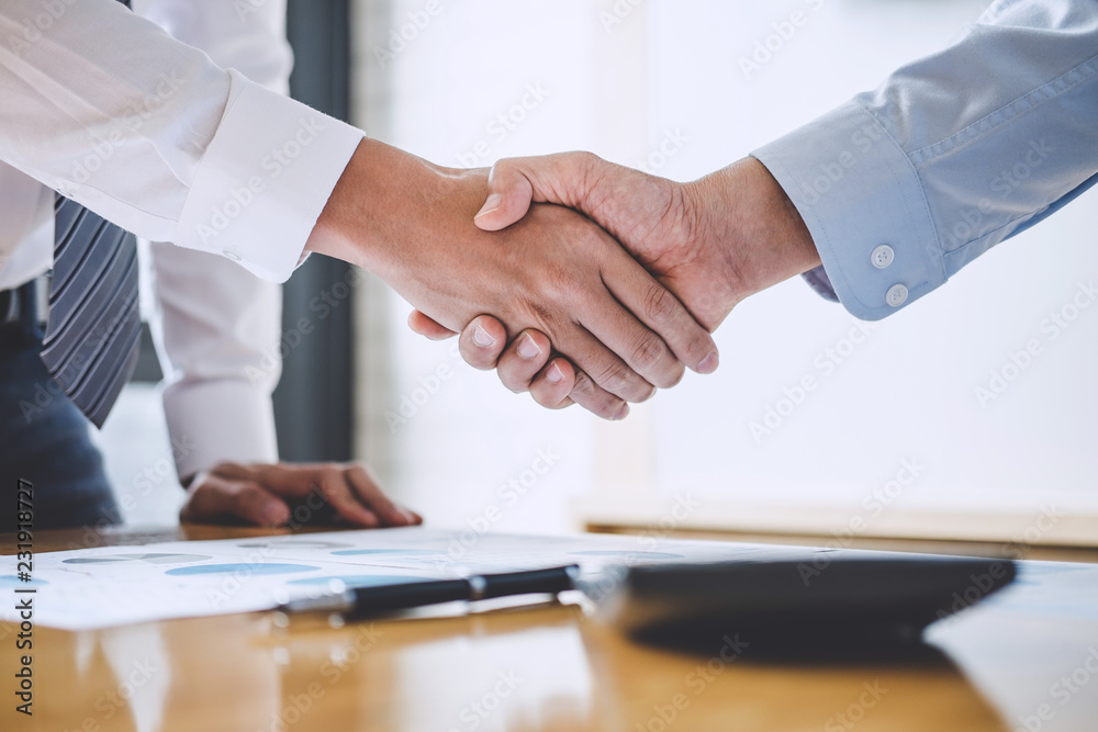 Business team greeting and finishing up a meeting, Two Business handshake of collaboration after discussing in team good deal of Trading contract for both companies, Finance, accounting, investment
