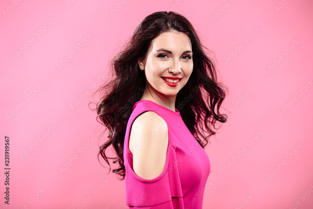 Beauty portrait of young brunette woman on a bright pink background. Model with make-up and hairstyle, closeup, fashion glamour photo Beauty portrait of young brunette woman on a bright pink background. Model with make-up and hairstyle, closeup, fashion glamour photo