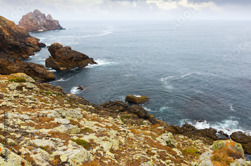 Cliffs at ocean  coast  in  cloudy day