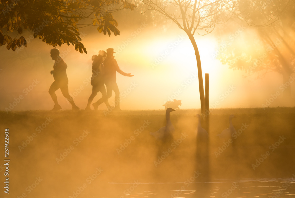 people enjoying the benefits of early morning sun seen through mist on the Avon
