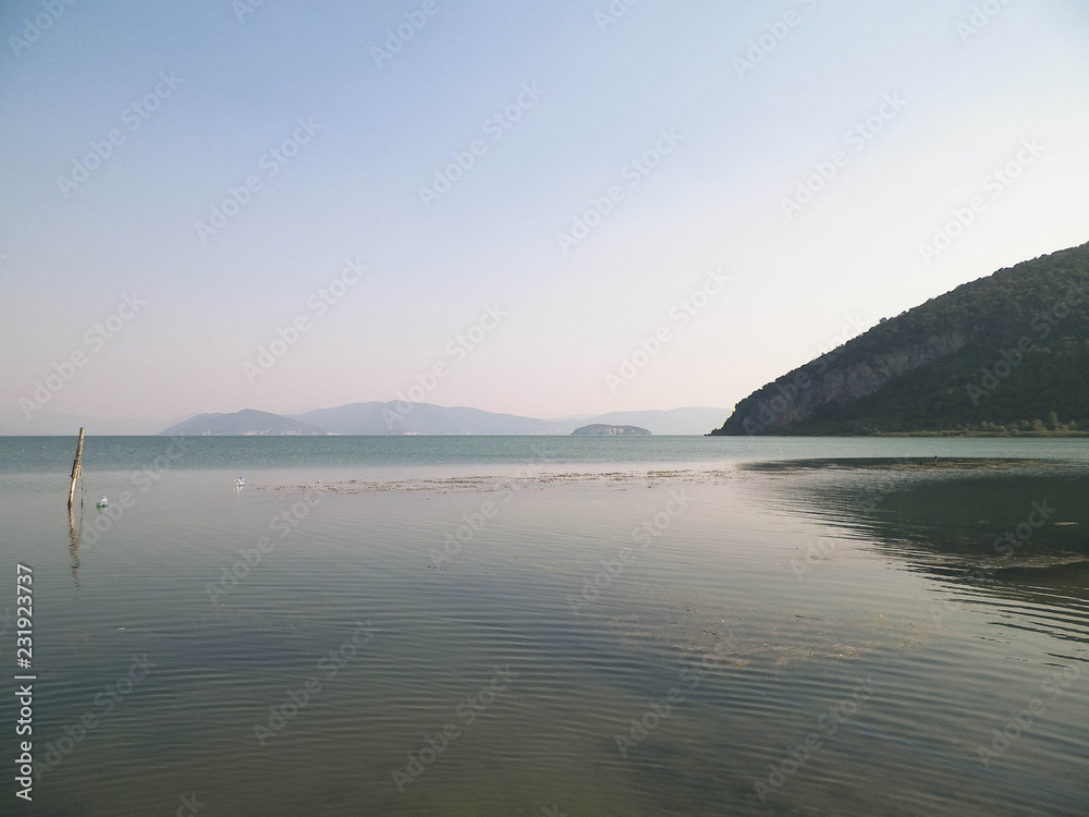 Coast of Lake Prespa and Mountains of Galicica National Park.
