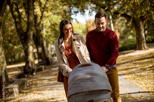 Happy young parents walking...