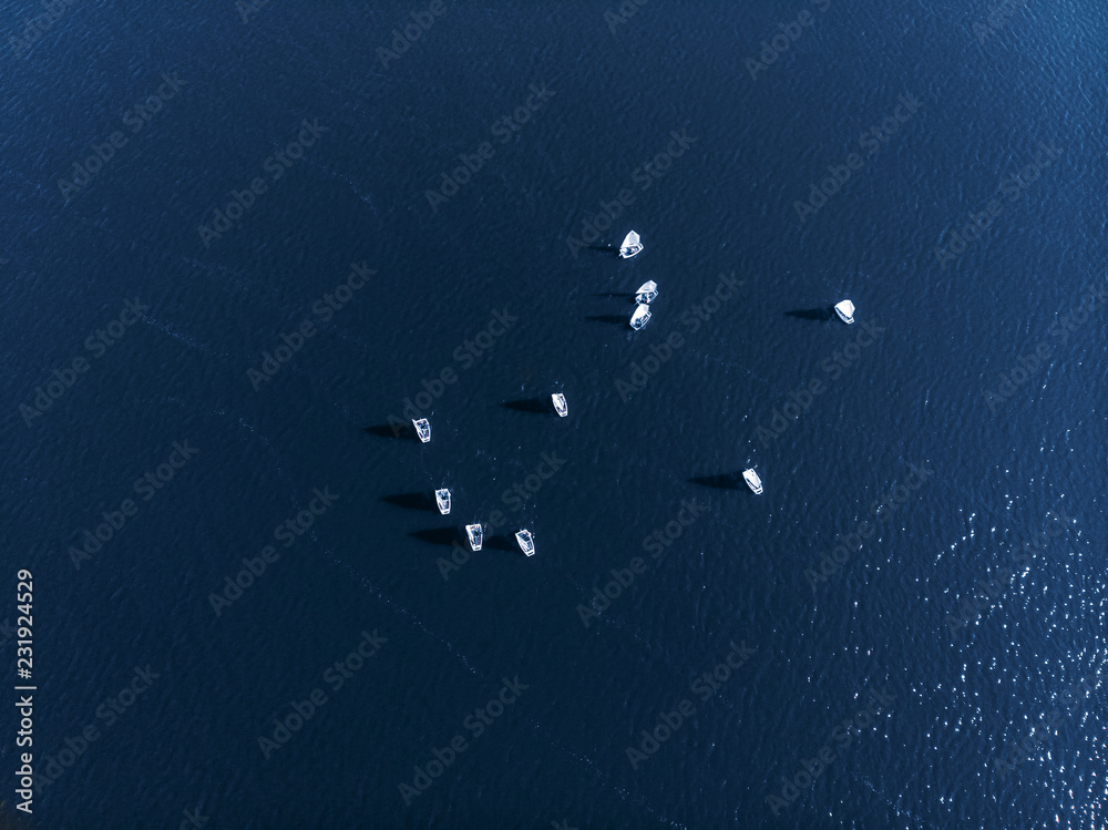 Aerial drone competitions sport white yachts and boats on blue water of sea. Aerial drone competitions sport white yachts and boats on blue water of sea.