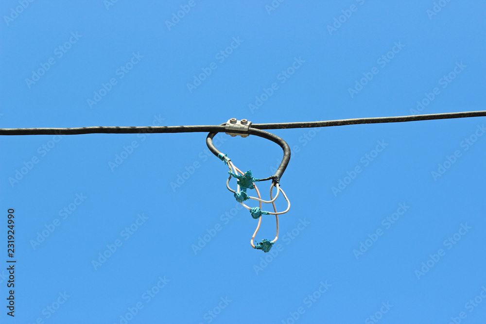 Inadequate unfitting connected connection electrical wires tape isolated composition detail blue sky Inadequate unfitting connected connection electrical wires tape isolated composition detail blue sky