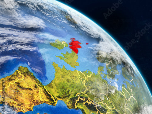 Scotland from space on realistic model of planet Earth with country borders and detailed planet surface and clouds.