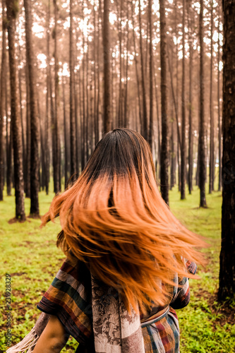Happiness woman flicking her hair in a forest © Nuthasak