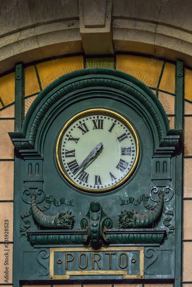 View of classic retro wall clock at the train station of St. Bento in Porto city