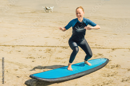 Photography Young woman is training to stand on the surf before the first surfing lesson