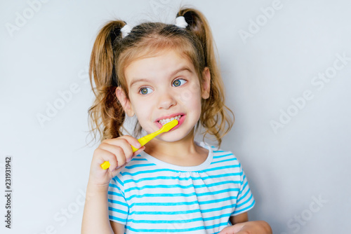 children's dental hygiene. child brushes his teeth with a toothbrush. health care, dental hygiene, people and beauty concept. mockup, free spase. selective focus. 