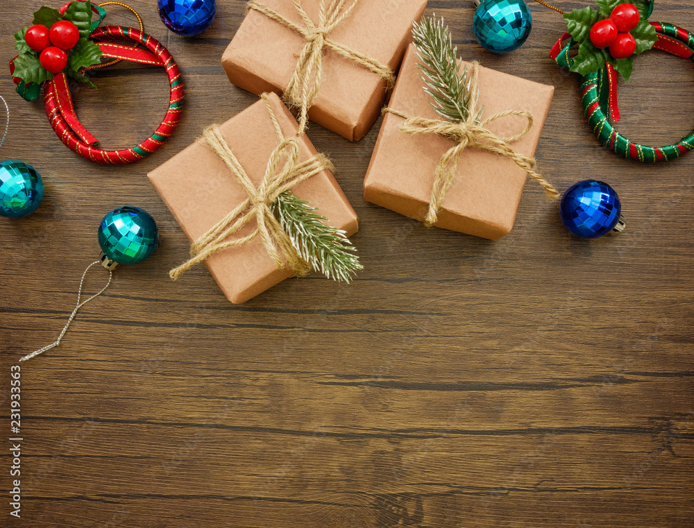 Flat lay,top view Christmas ornaments and gift boxes on wooden background with copy space 