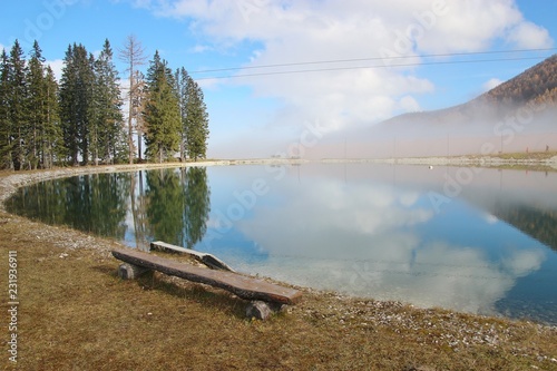 View of a reservoir lake for artificial snow, in autumn. A layer of fog around. Height approx. 1300 m. Hinterstoder, Upper Austria, Europe.