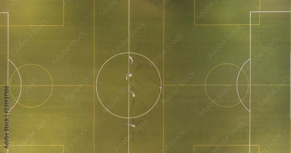 Top view of soccer players running around the field. Night workout. Top view of soccer players running around the field. Night workout.