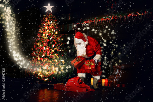 Christmas night, Santa Claus puts gifts under the tree © Zarya Maxim