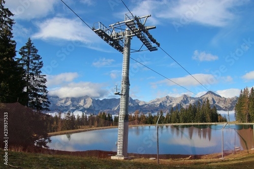 View of a reservoir lake for artificial snow, a ski lift and surrounding mountains, in autumn. Height approx. 1300 m.  Hinterstoder, Upper Austria, Europe.