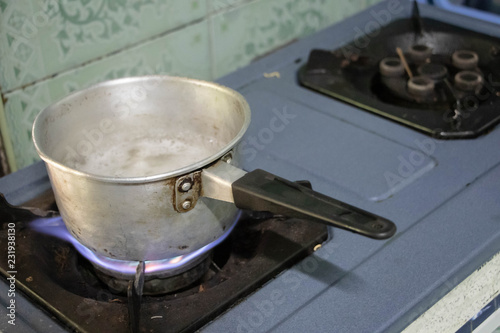 Boiling water in pan in kitchen