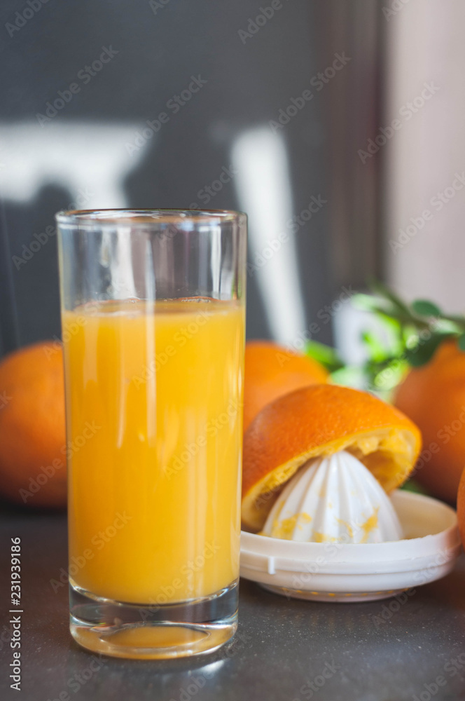 Oranges and juicer for making orange juice.. Black-gray background. Oranges and juicer for making orange juice.. Black-gray background.
