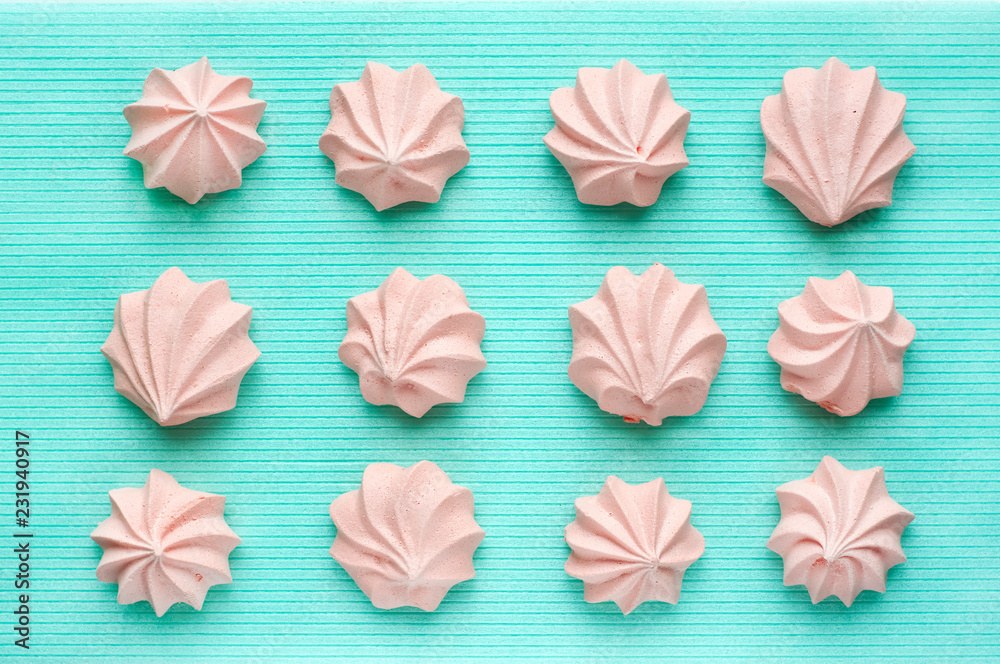 Creamy pink meringue on a background of mint color