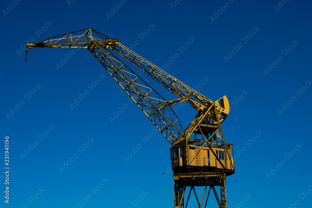 Old crane in Puerto Madero neighborhood, the newest barrio (district) of Buenos Aires, Argentina Old crane in Puerto Madero neighborhood, the newest barrio (district) of Buenos Aires, Argentina