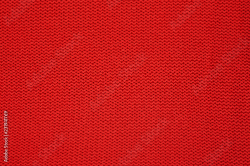 Red knitted texture. Handmade Knitwear. Background