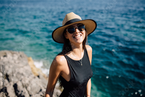 Portrait of beautiful brunette woman in bikini on the shore