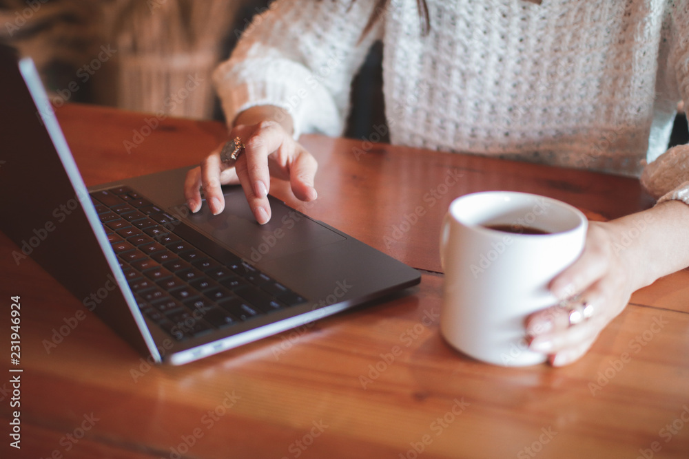 Fototapeta premium woman with cup of coffee and laptop