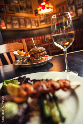 american hamburger with glass of beer of wine in american restaurant  product photography for restaurant in american style