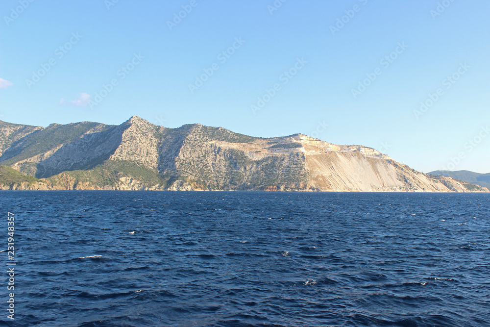 Sea landscape seascape deep blue calm sea ocean land island mountain hill on horizon