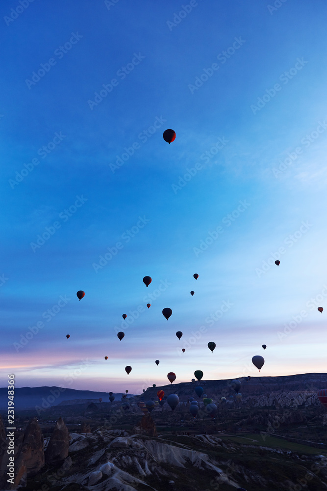 Mountain landscape with large balloons in a short summer season at dawn.