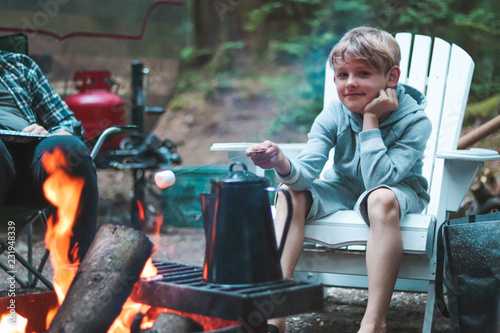 boy roasting a marshmallow over a campfire
