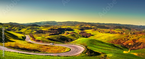 Tuscany landscape, road and green field. Volterra Italy