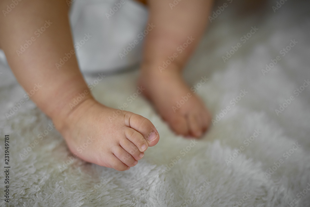 Soft newborn baby feet against a pink blanket. Soft newborn baby feet against a pink blanket.