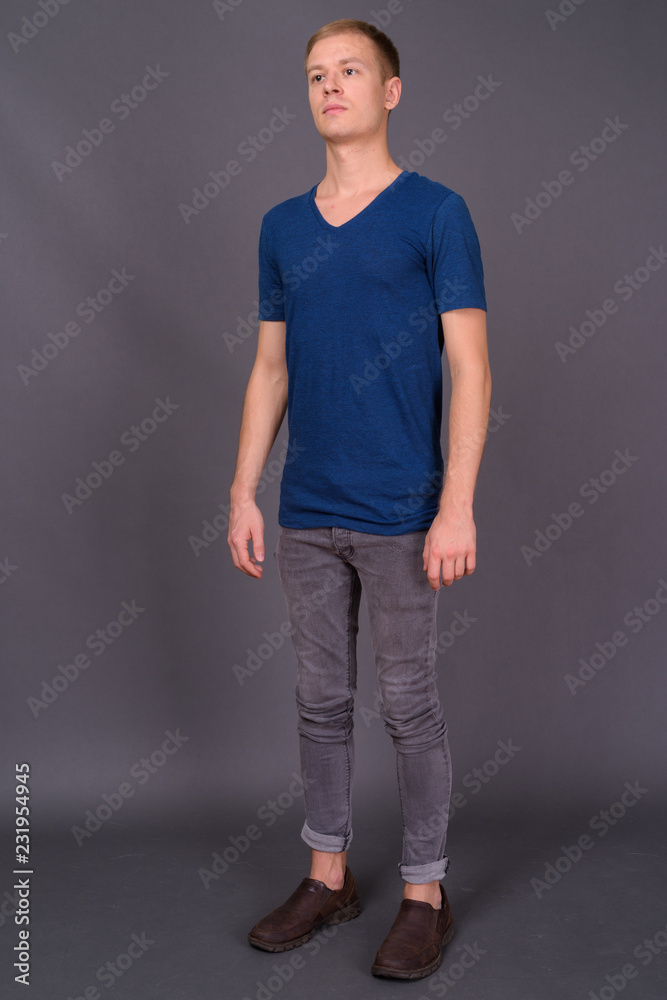 Portrait of young handsome man against gray background Portrait of young handsome man against gray background