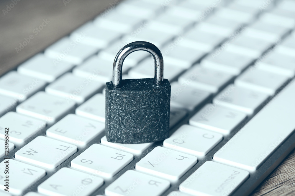 security lock on white computer keyboard security lock on white computer keyboard