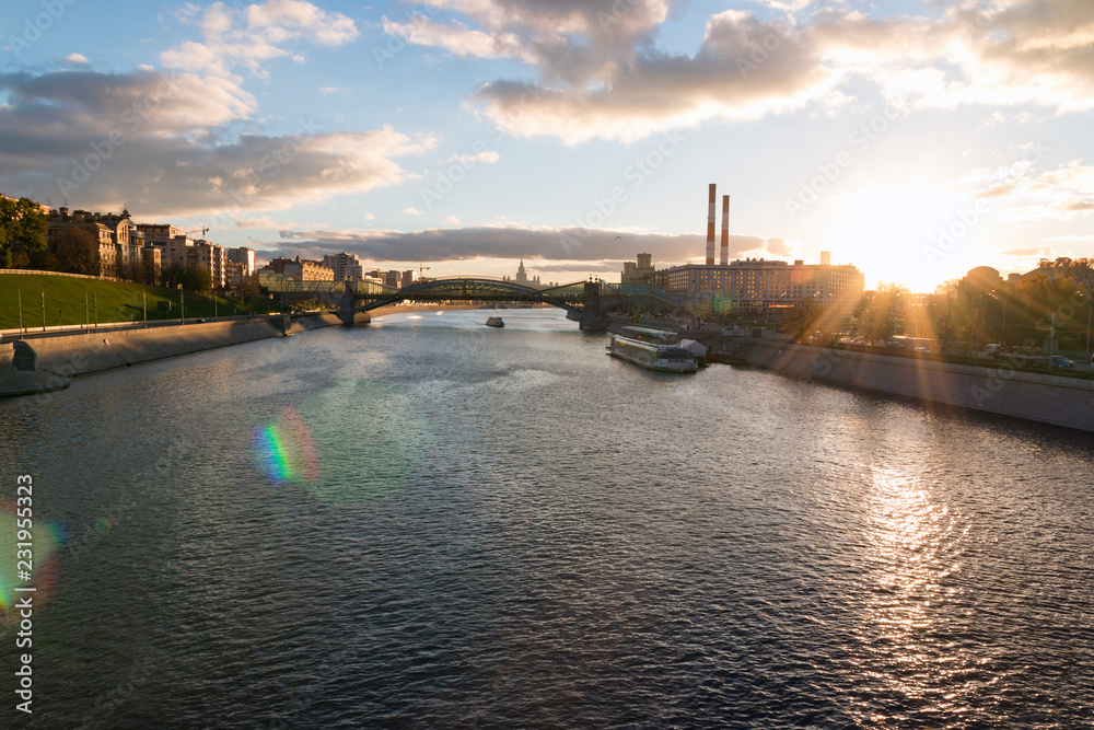 View of the Moscow river from Borodinsky bridge near the Kiyevsky railway station at sunset