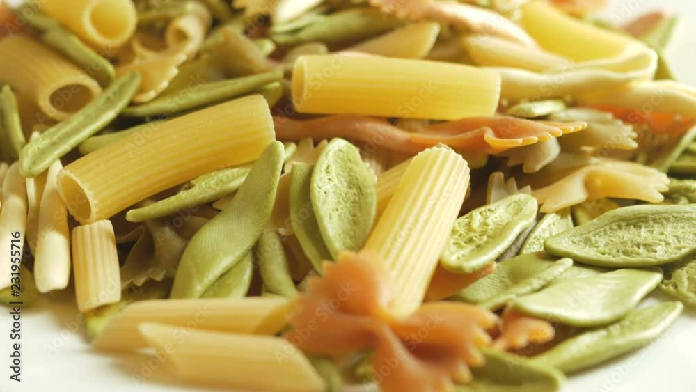 mixed colorfull dry pasta Fusilli, farfalle rotate on white background mixed colorfull dry pasta Fusilli, farfalle rotate on white background