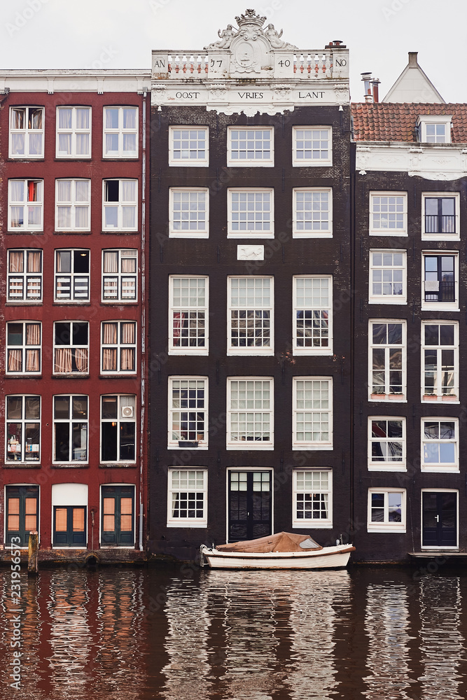 Typical dutch architecture, canal and boat in Amsterdam