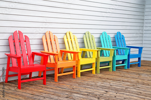 Various coloured wooden chairs 