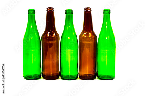 Colored empty glass bottles on white background