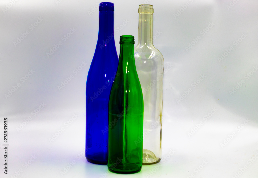 Colored empty glass bottles on white background Colored empty glass bottles on white background