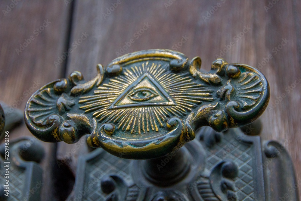 All seeing eye of illuminati on a door knob of the Illuminati freemason in  Stockholm, Sweden. Stock Photo | Adobe Stock