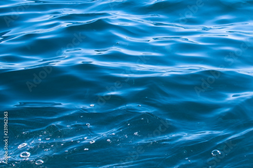 small blue sea waves form a pattern.