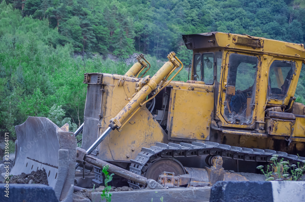 Excavator in an outdoor mine perform stone movement