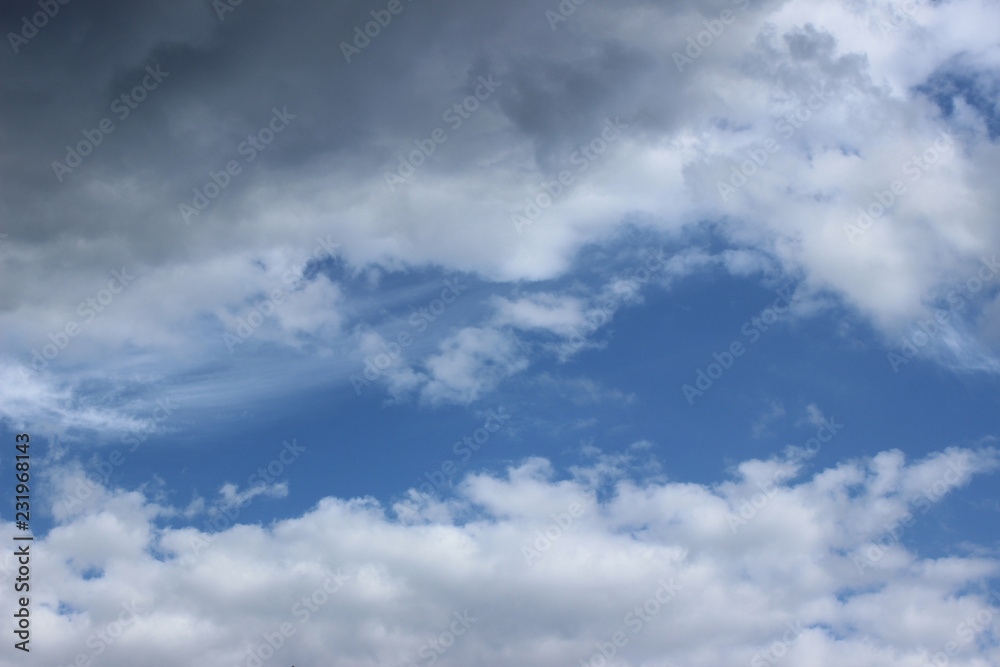 Horizontal white and gray clouds over blue sky Horizontal white and gray clouds over blue sky
