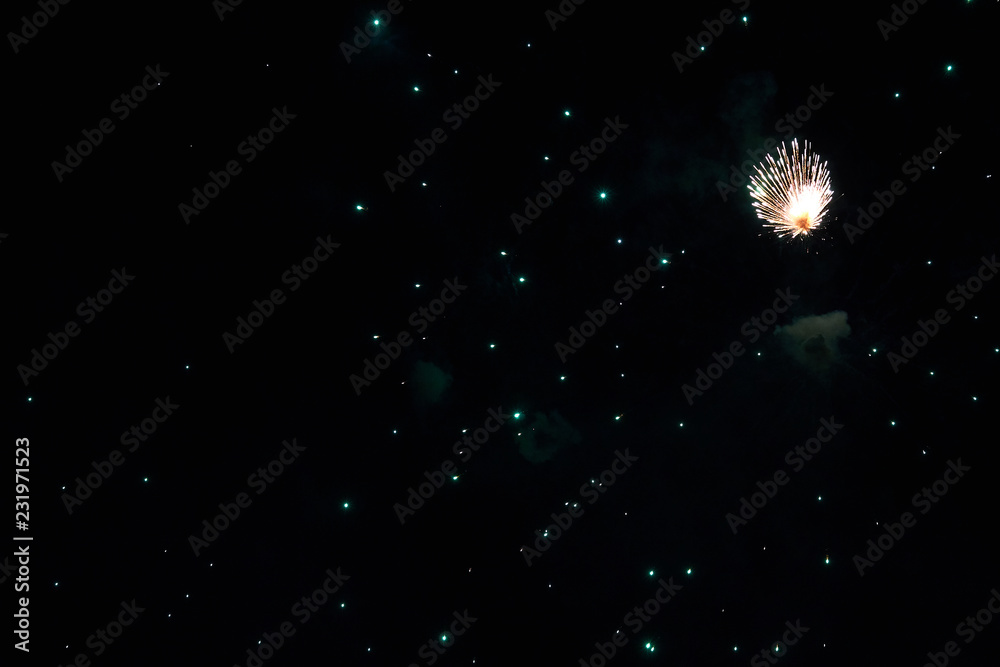Fireworks in the night sky. Texture salute. Abstract photo of flares on a black background. Photos of lights salute in the sky. Image of salute flashes. Texture of colored lights.