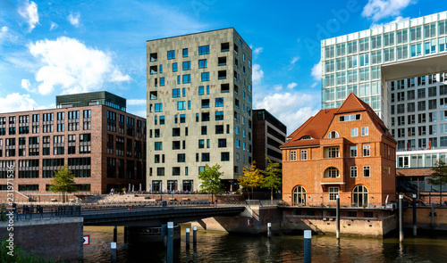 the ericus bridge on the hamburg warehouse district with the mirror publishing house and an old building, germany © spuno
