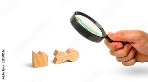 Magnifying glass is looking at a wooden figure of a man is broken. The concept of psychological stress and pressure. Could not stand our nerves and our health. Threat of life. Never give up Motivation