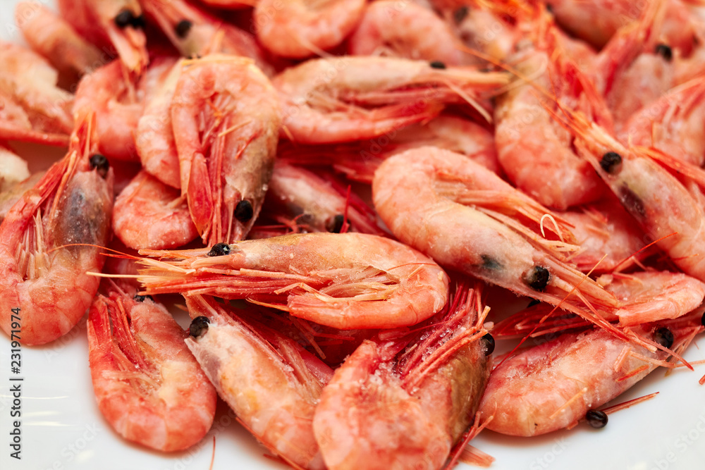 Shrimp. Shrimps lie on a plate. Boiled ready-to-eat shrimp. A large dish of small shrimps. Shrimp. Shrimps lie on a plate. Boiled ready-to-eat shrimp. A large dish of small shrimps.