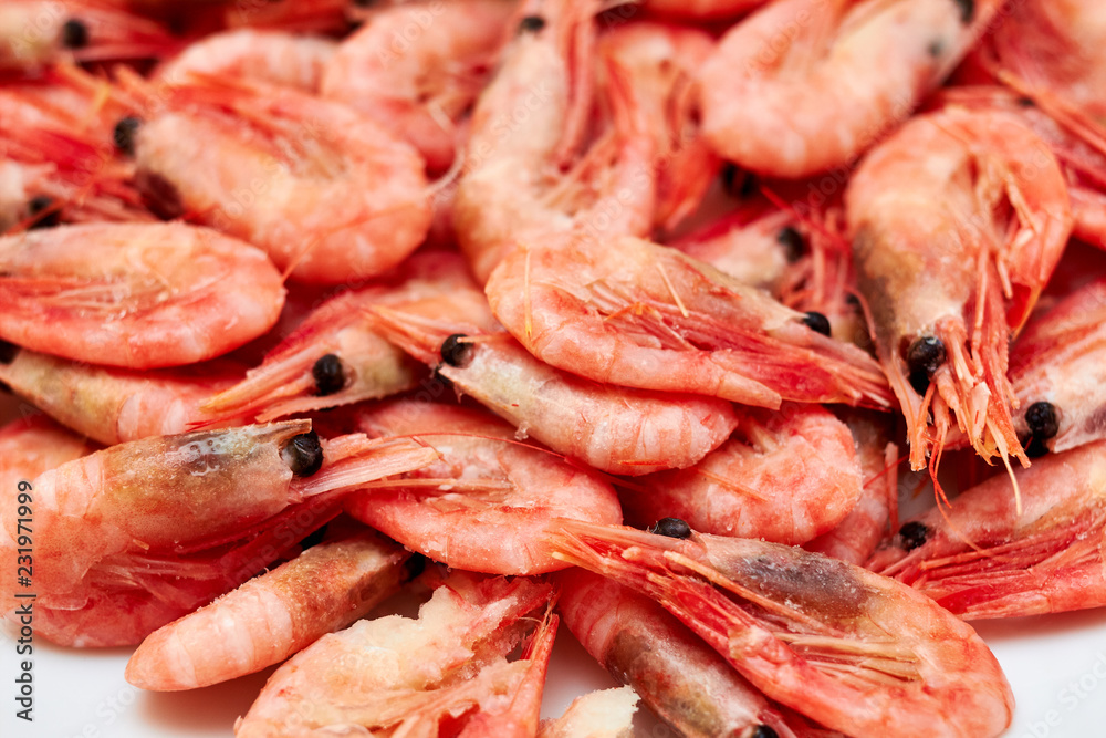 Shrimp. Shrimps lie on a plate. Boiled ready-to-eat shrimp. A large dish of small shrimps. Shrimp. Shrimps lie on a plate. Boiled ready-to-eat shrimp. A large dish of small shrimps.