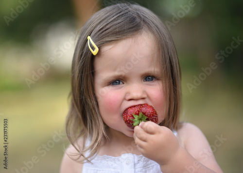 portrait of little girl outdoors in summer